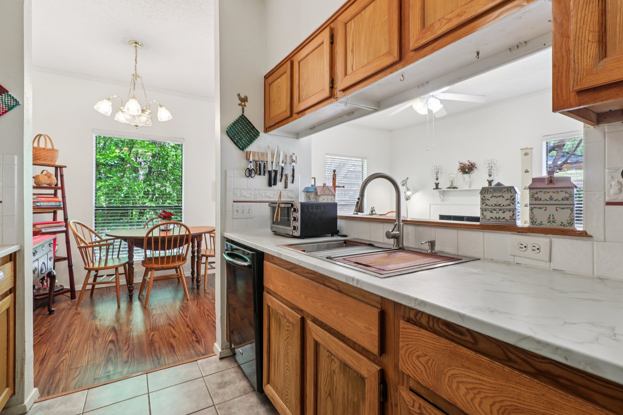 802 South 1st Street, Unit 121 Austin, TX 78704 - Photo 6 of 12 a kitchen with a sink a counter and chairs