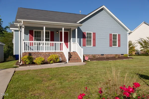 a view of house with yard
