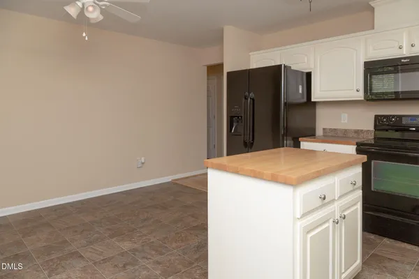 a kitchen with a appliances a refrigerator and a stove top oven