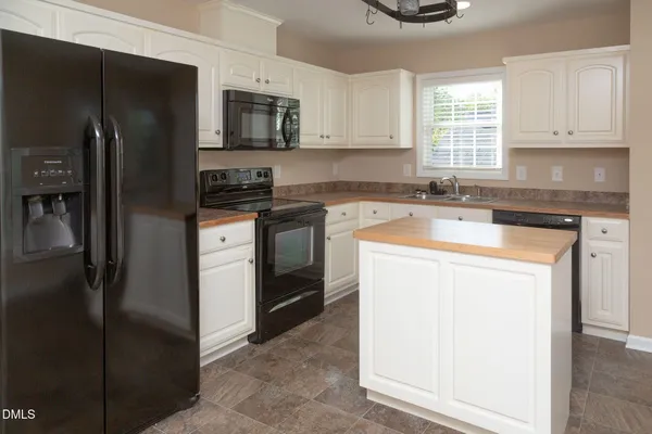 a kitchen with a sink stove and refrigerator