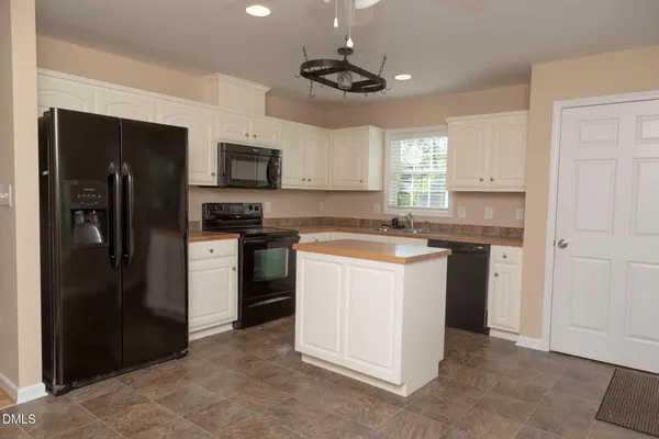a kitchen with a refrigerator stove and microwave