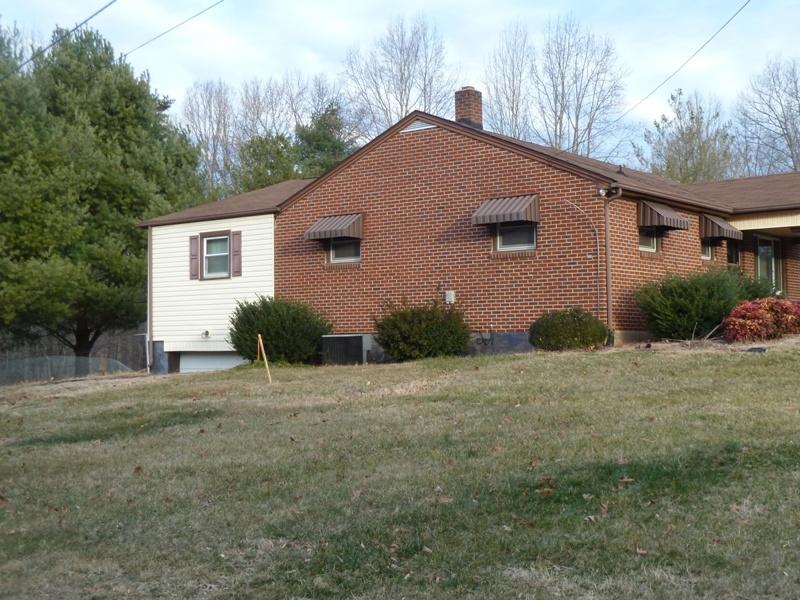 2275 Iron Ridge Road Rocky Mount, VA 24151 - Photo 13 of 16 a front view of a house with a yard and garage