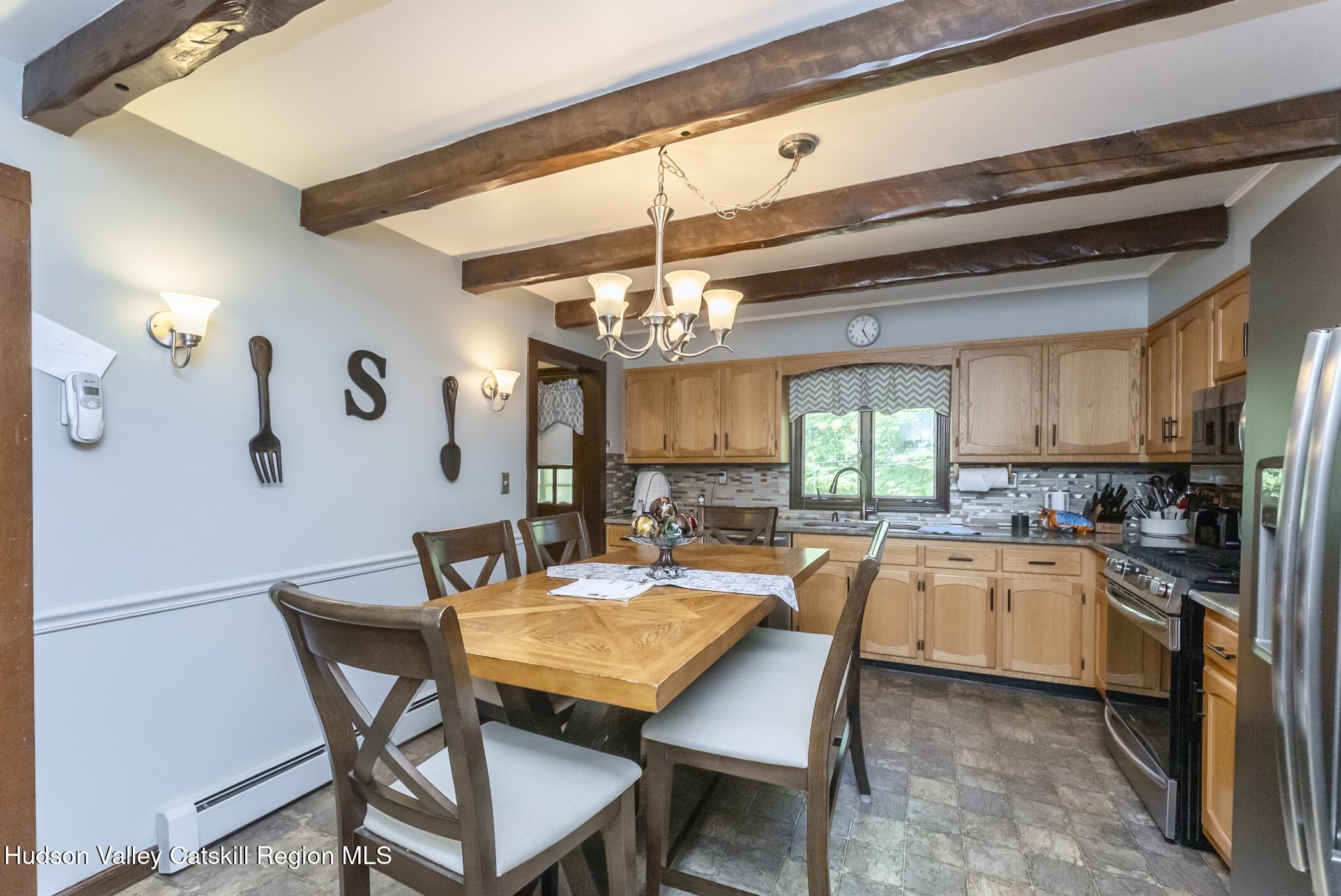 135 Hilltop Road Saugerties, NY 12477 - Photo 13 of 49 a dining area with a table and chairs