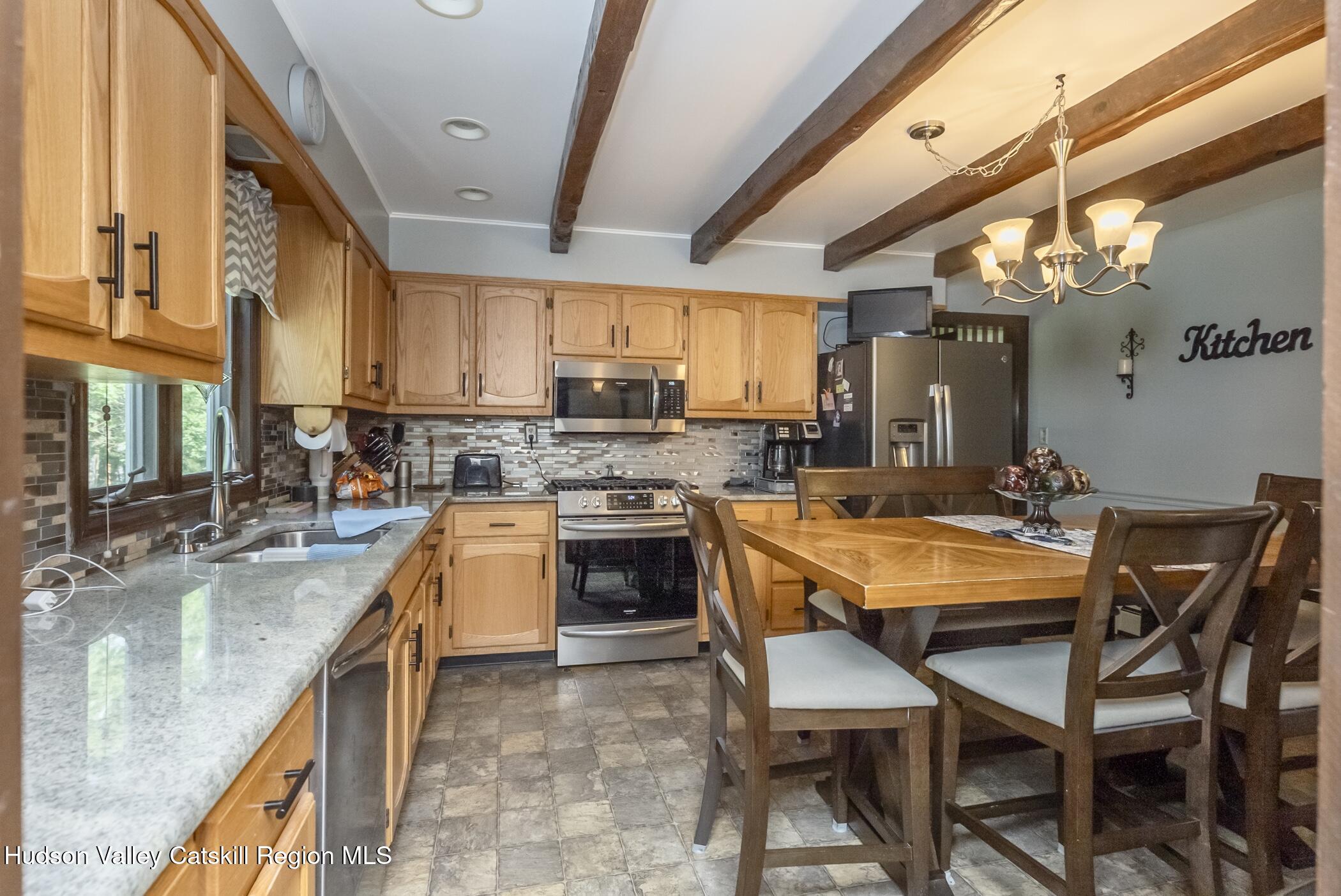 135 Hilltop Road Saugerties, NY 12477 - Photo 14 of 49 a kitchen with a table chairs sink and cabinets