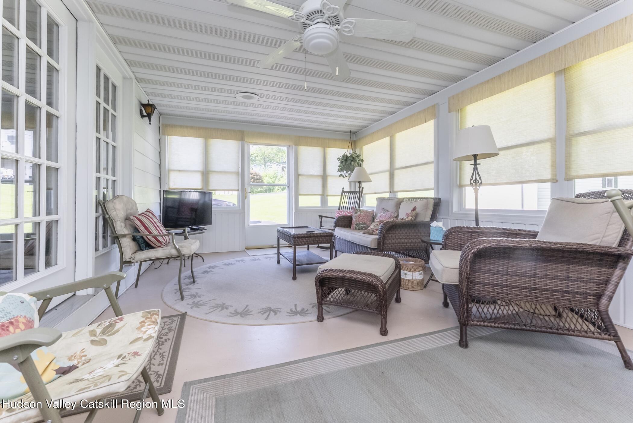 135 Hilltop Road Saugerties, NY 12477 - Photo 18 of 49 a living room with furniture a flat screen tv and a large window