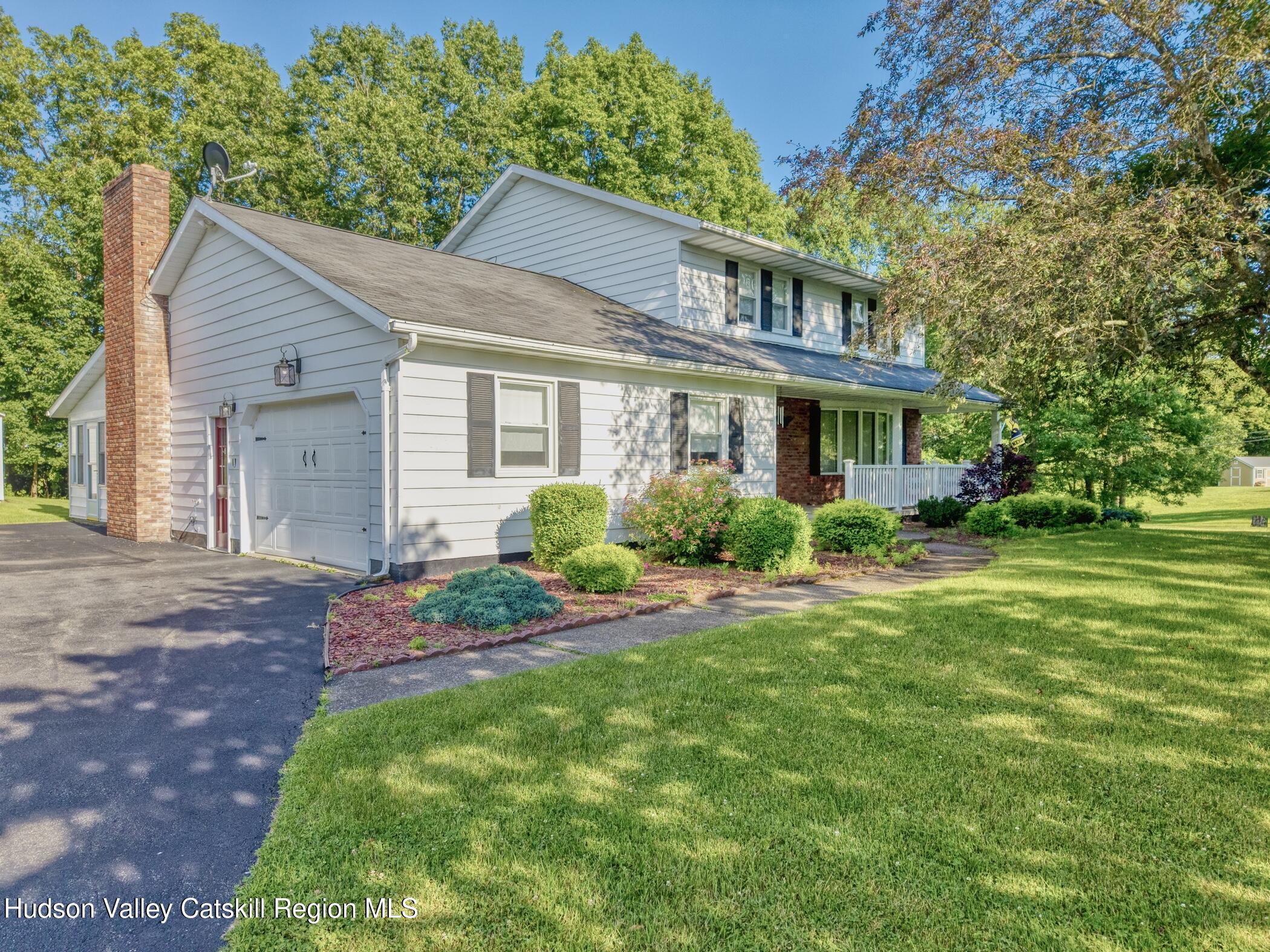 135 Hilltop Road Saugerties, NY 12477 - Photo 2 of 49 a front view of a house with a yard and potted plants