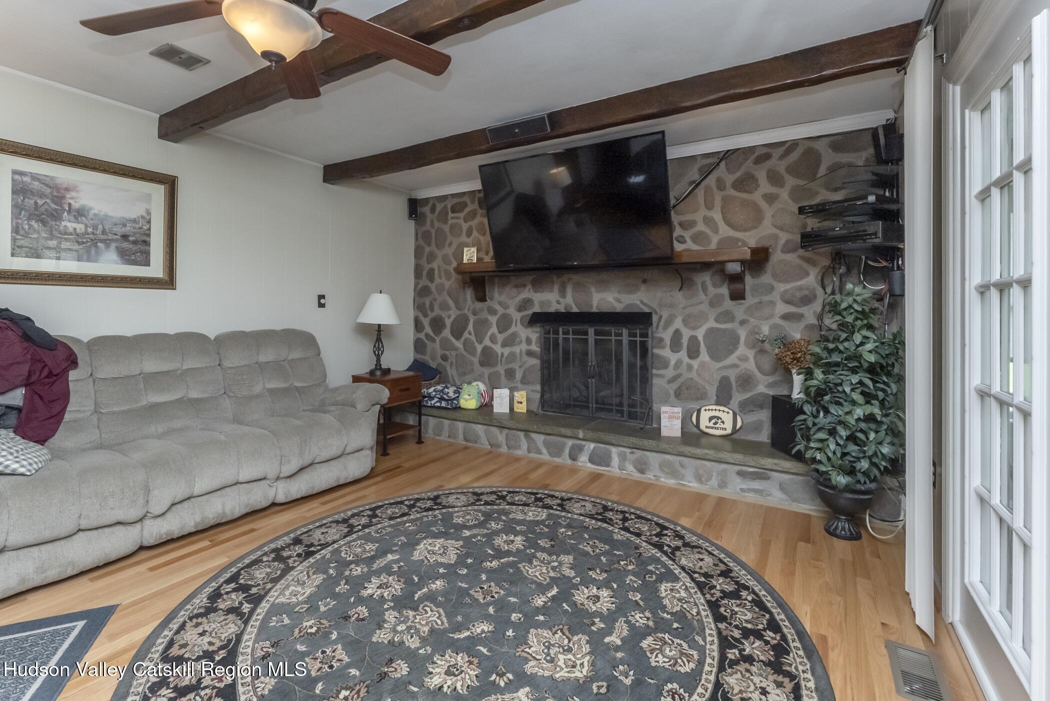 135 Hilltop Road Saugerties, NY 12477 - Photo 22 of 49 a living room with a couch and a fireplace