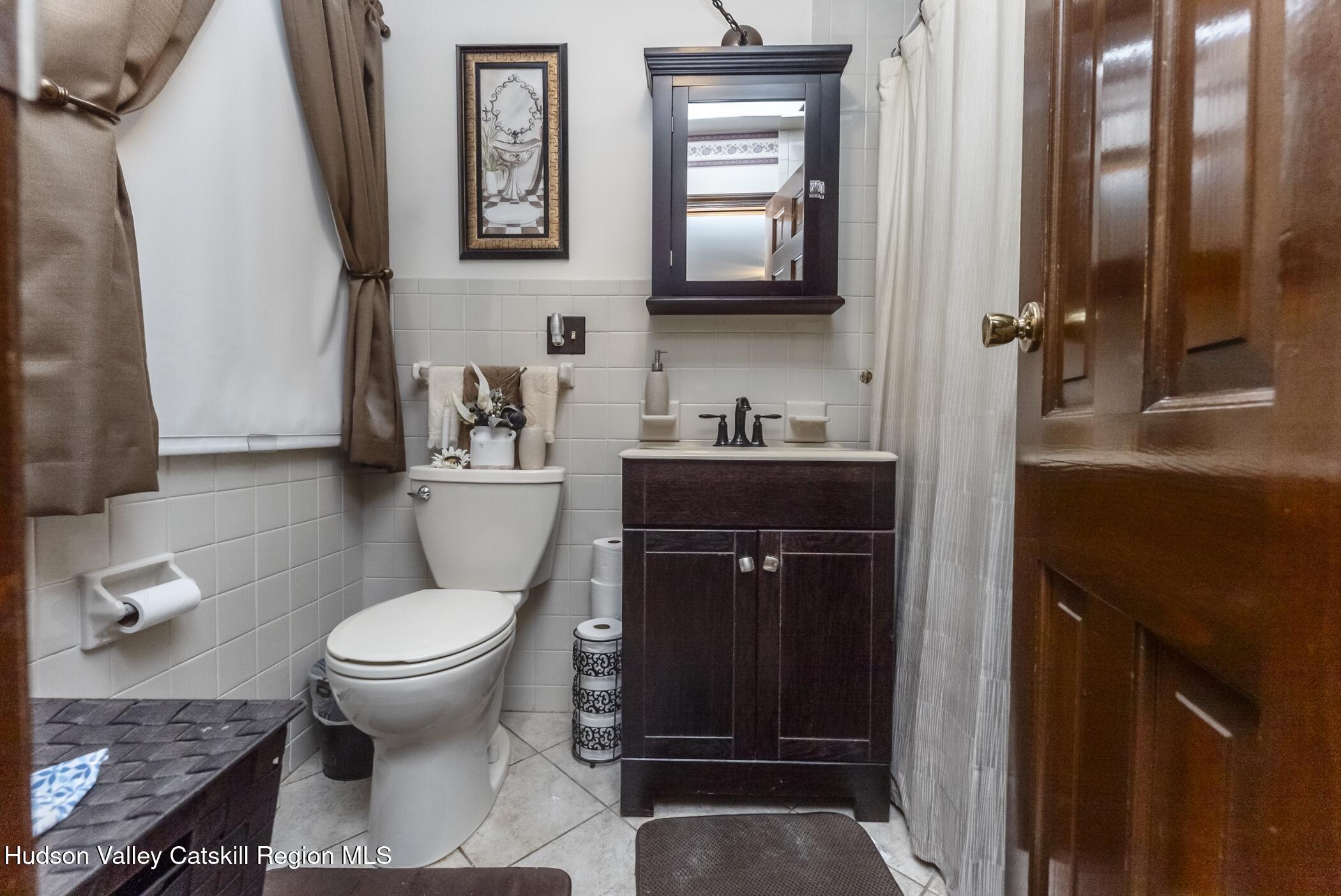 135 Hilltop Road Saugerties, NY 12477 - Photo 28 of 49 a bathroom with a toilet a sink and mirror