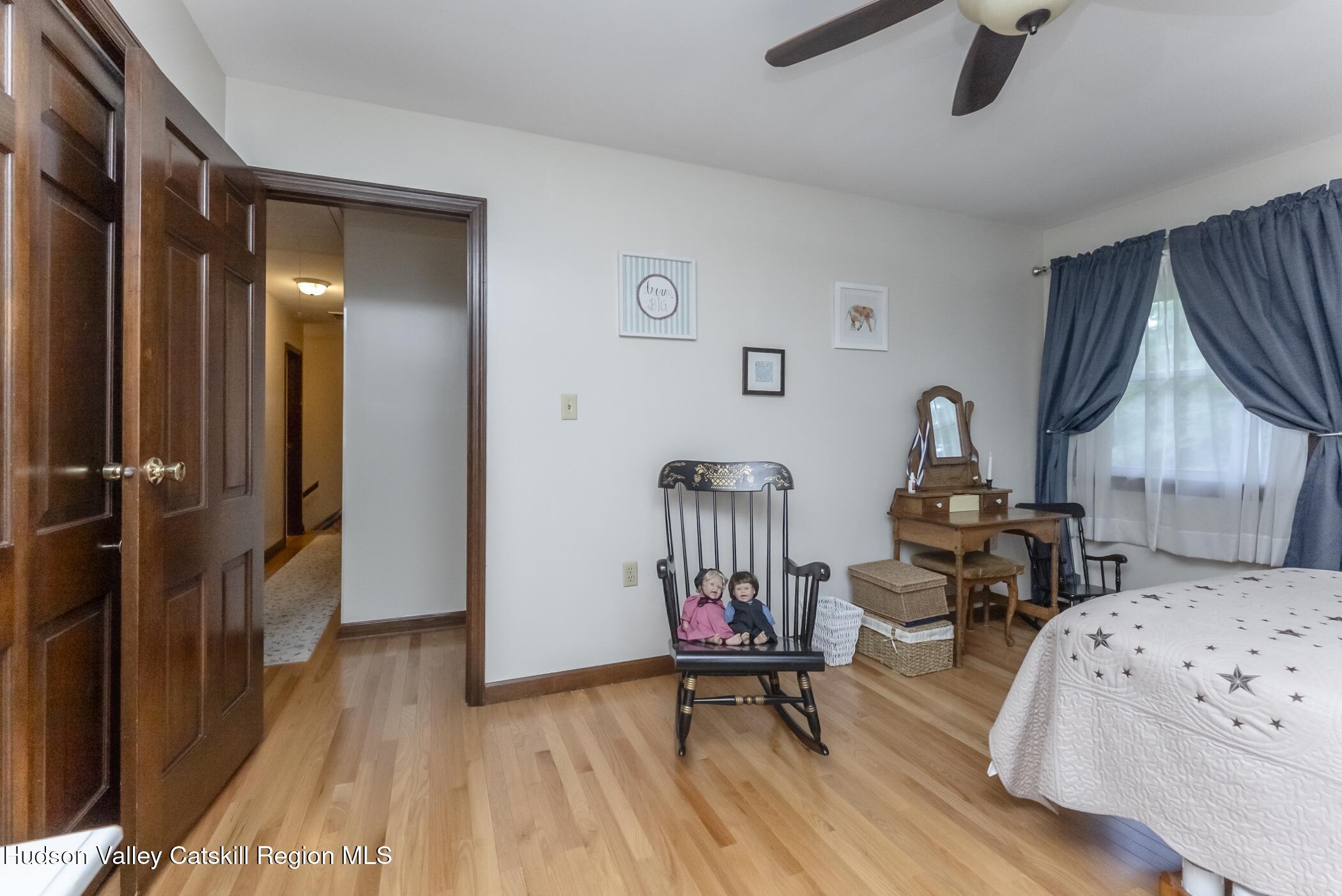 135 Hilltop Road Saugerties, NY 12477 - Photo 30 of 49 a bedroom with furniture and a wooden floor