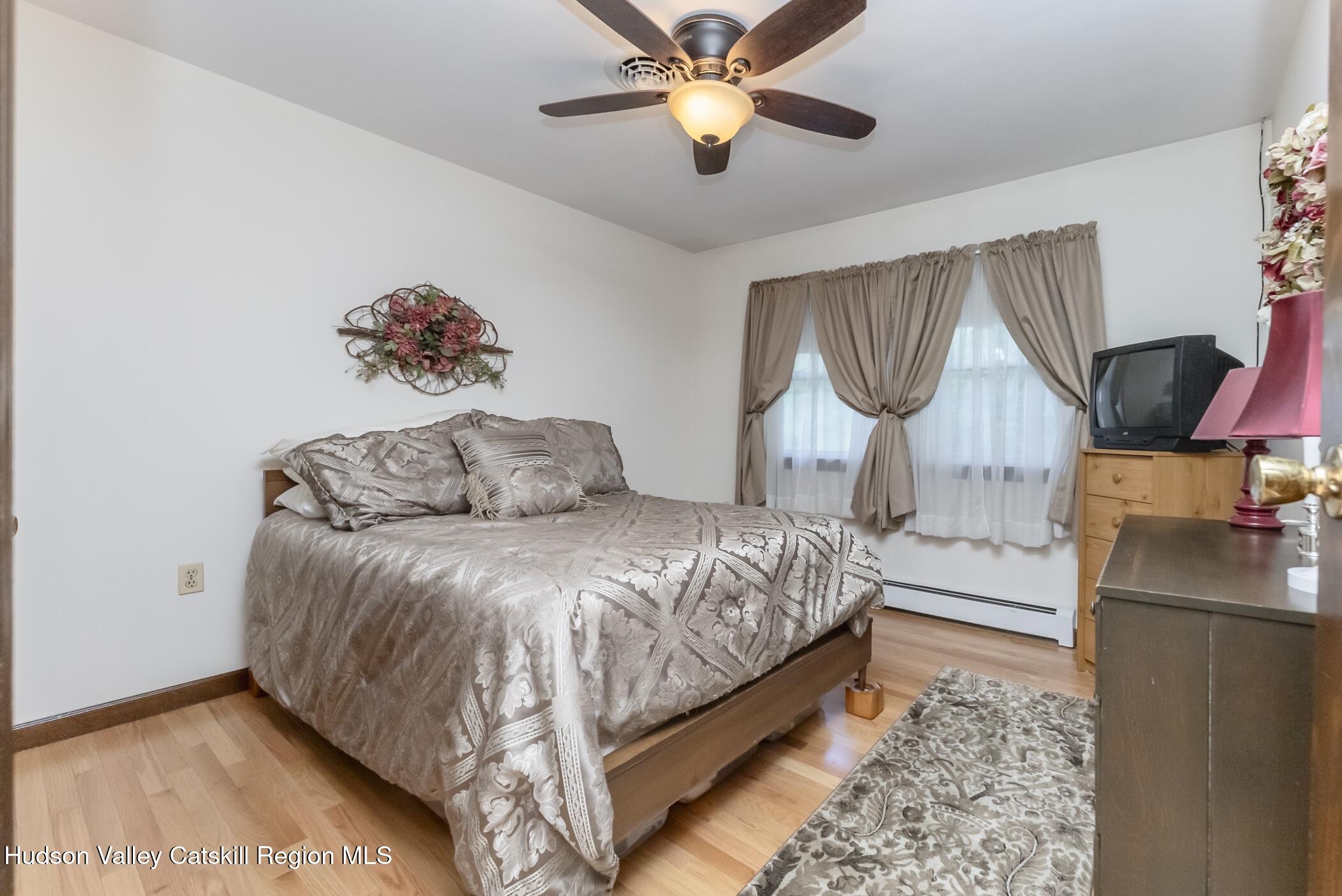 135 Hilltop Road Saugerties, NY 12477 - Photo 31 of 49 a bedroom with a bed and a chandelier