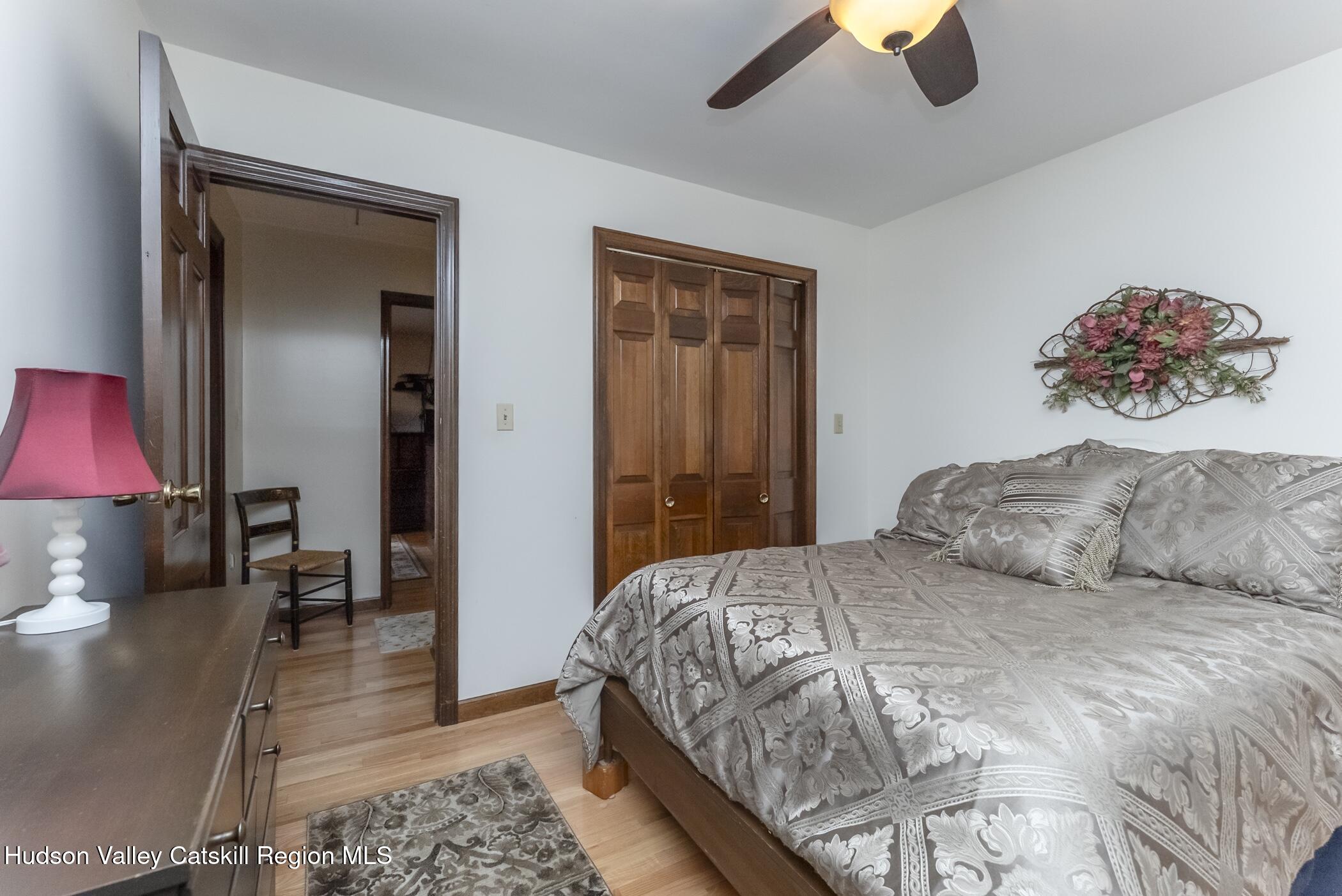 135 Hilltop Road Saugerties, NY 12477 - Photo 32 of 49 a bedroom with a bed and a chandelier