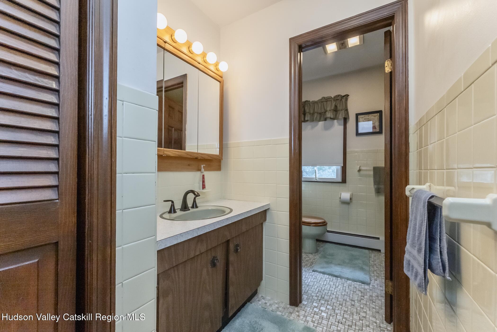 135 Hilltop Road Saugerties, NY 12477 - Photo 33 of 49 a bathroom with a sink and a mirror