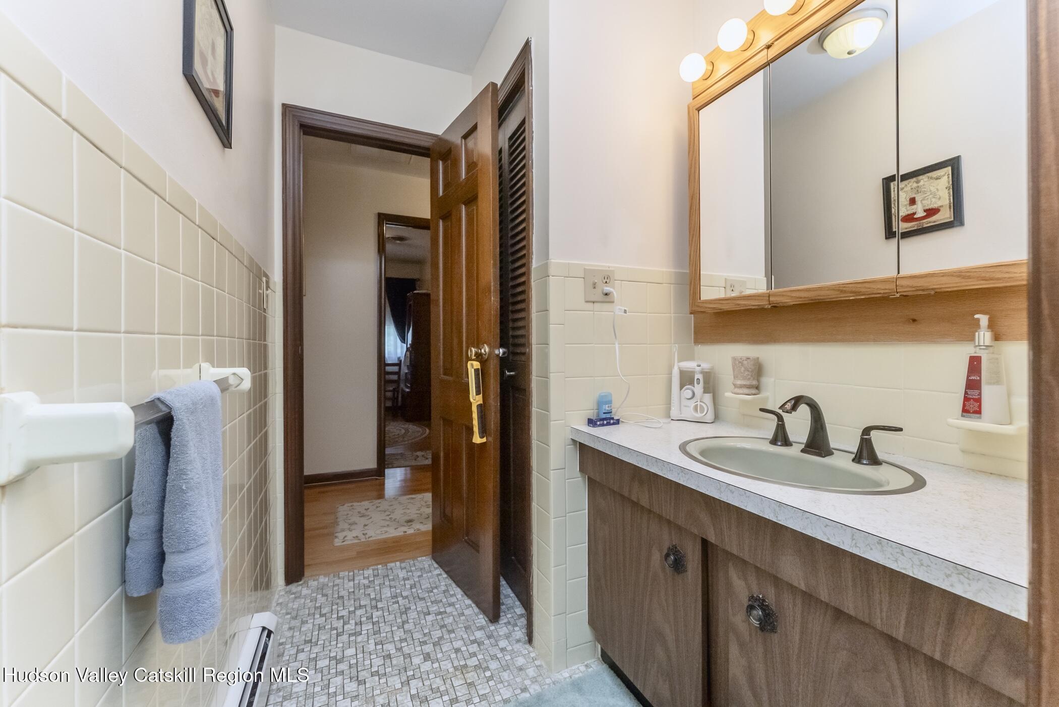 135 Hilltop Road Saugerties, NY 12477 - Photo 34 of 49 a bathroom with a sink and a mirror