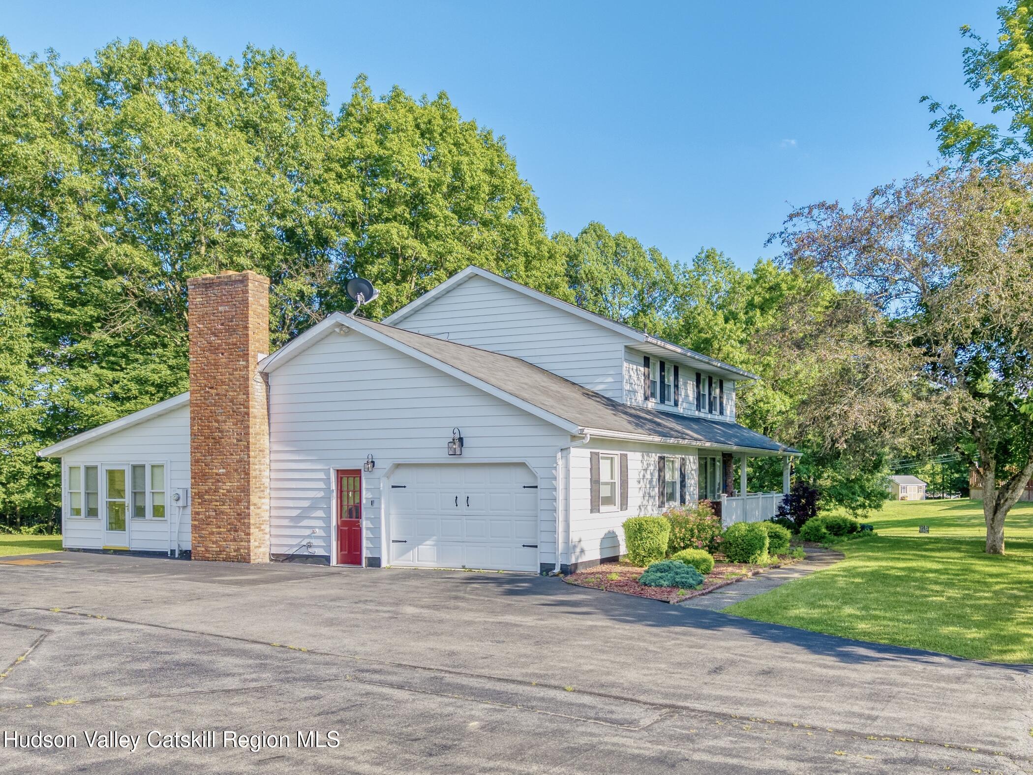 135 Hilltop Road Saugerties, NY 12477 - Photo 40 of 49 a view of a house with a yard and potted plants