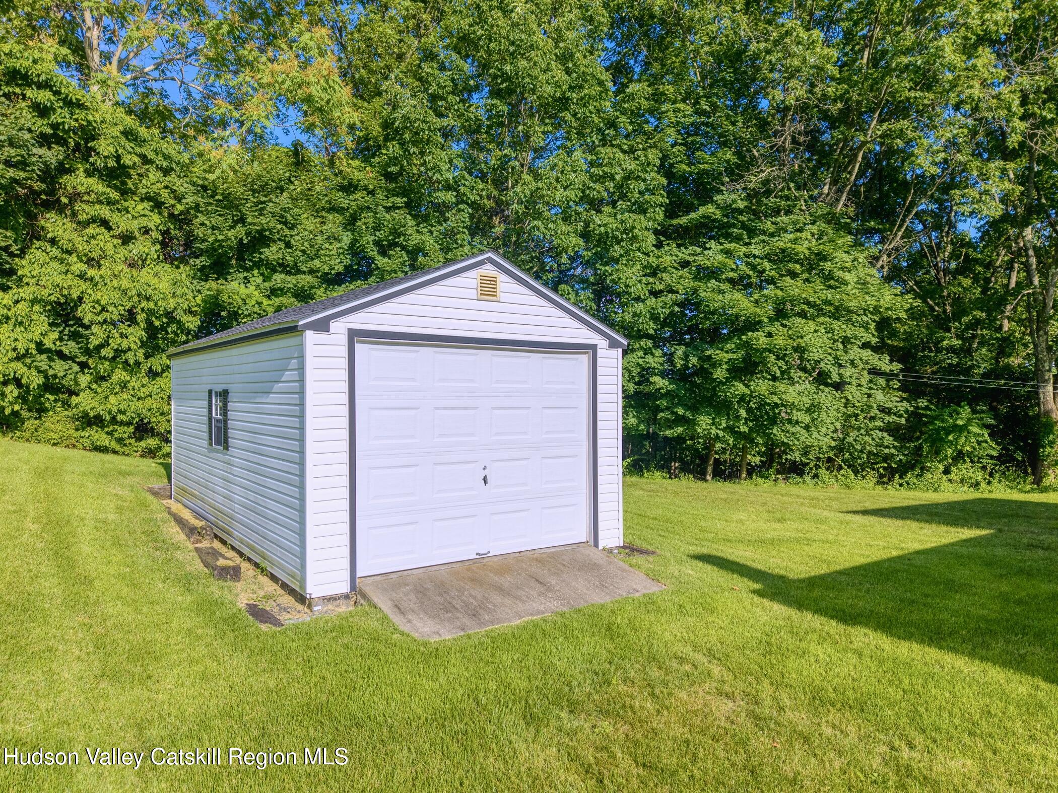 135 Hilltop Road Saugerties, NY 12477 - Photo 41 of 49 a view of a backyard with barn and wooden fence