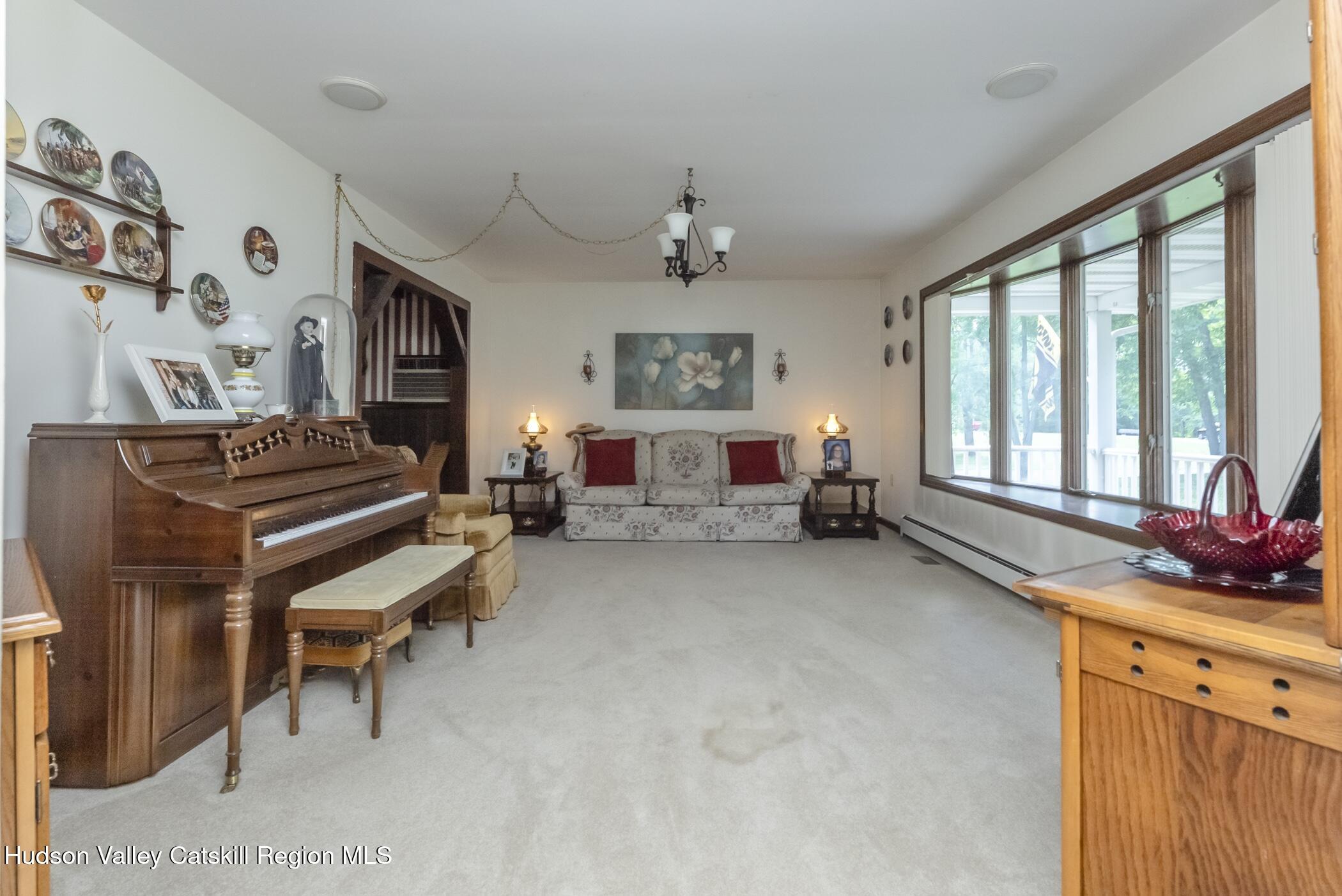135 Hilltop Road Saugerties, NY 12477 - Photo 6 of 49 a living room with furniture a piano and a window