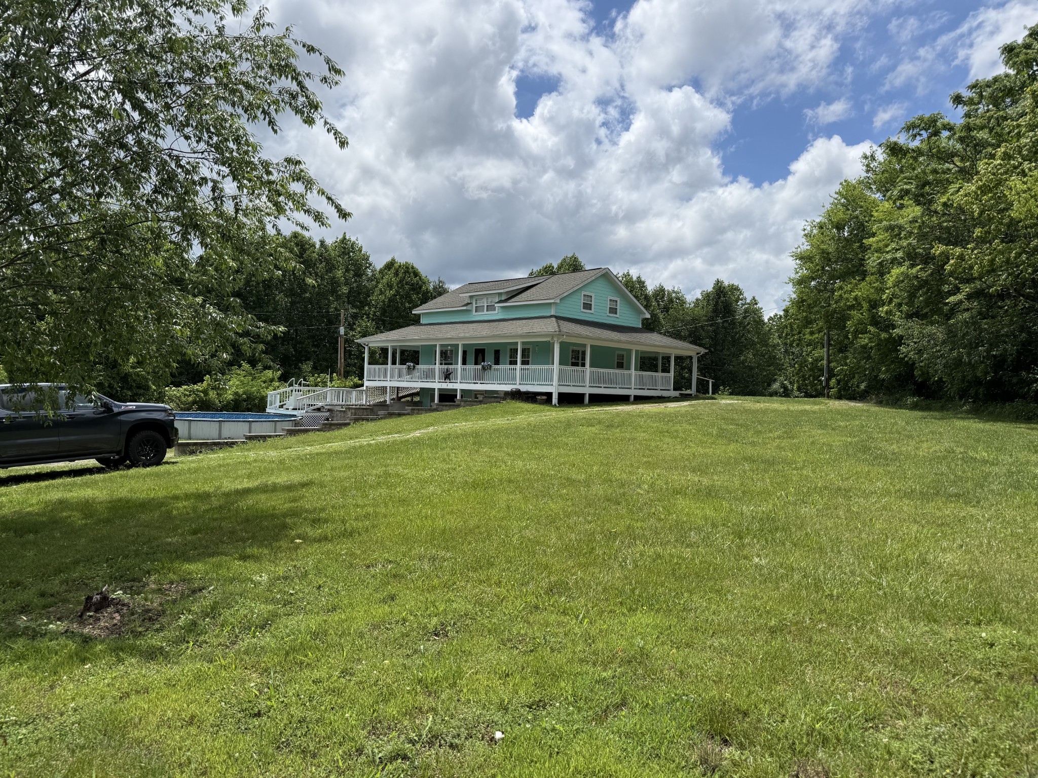 581 Shady Grove Road Bloomington Springs, TN 38545 - Photo 18 of 42 a view of a house with a big yard and sitting area