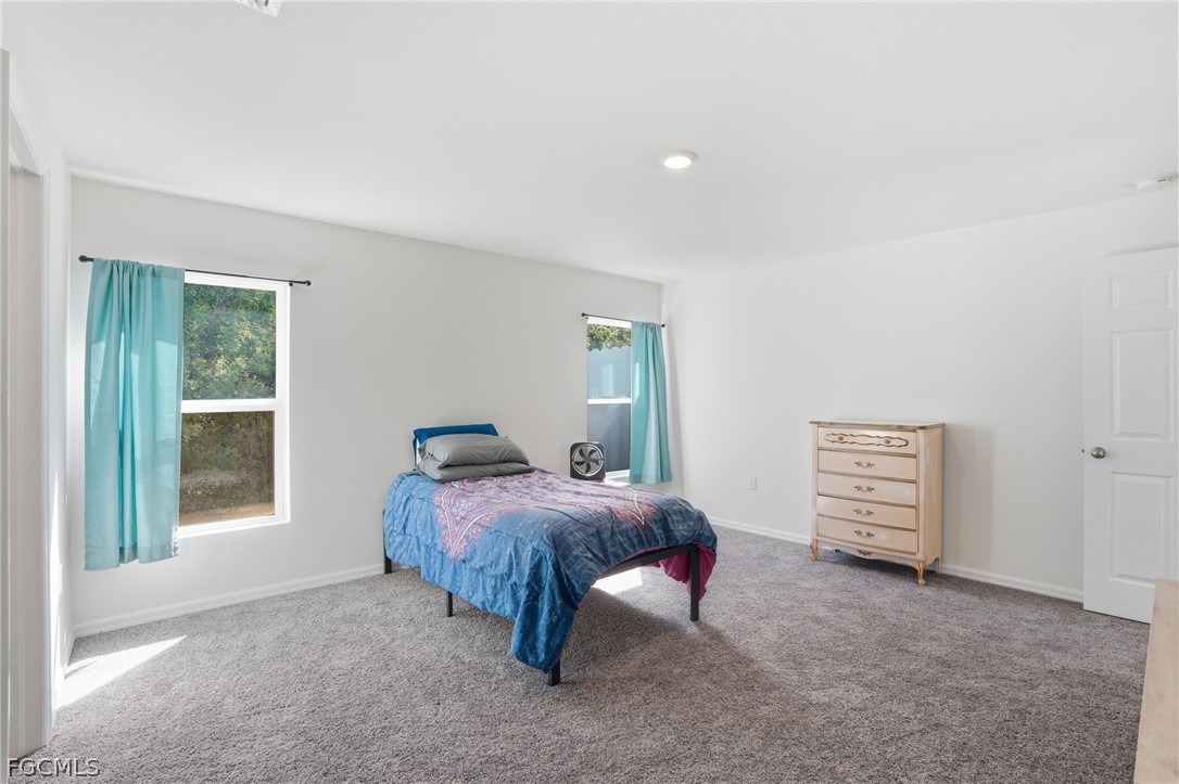 3319 40th Street West Lehigh Acres, FL 33971 - Photo 17 of 45 a bedroom with a bed and a window