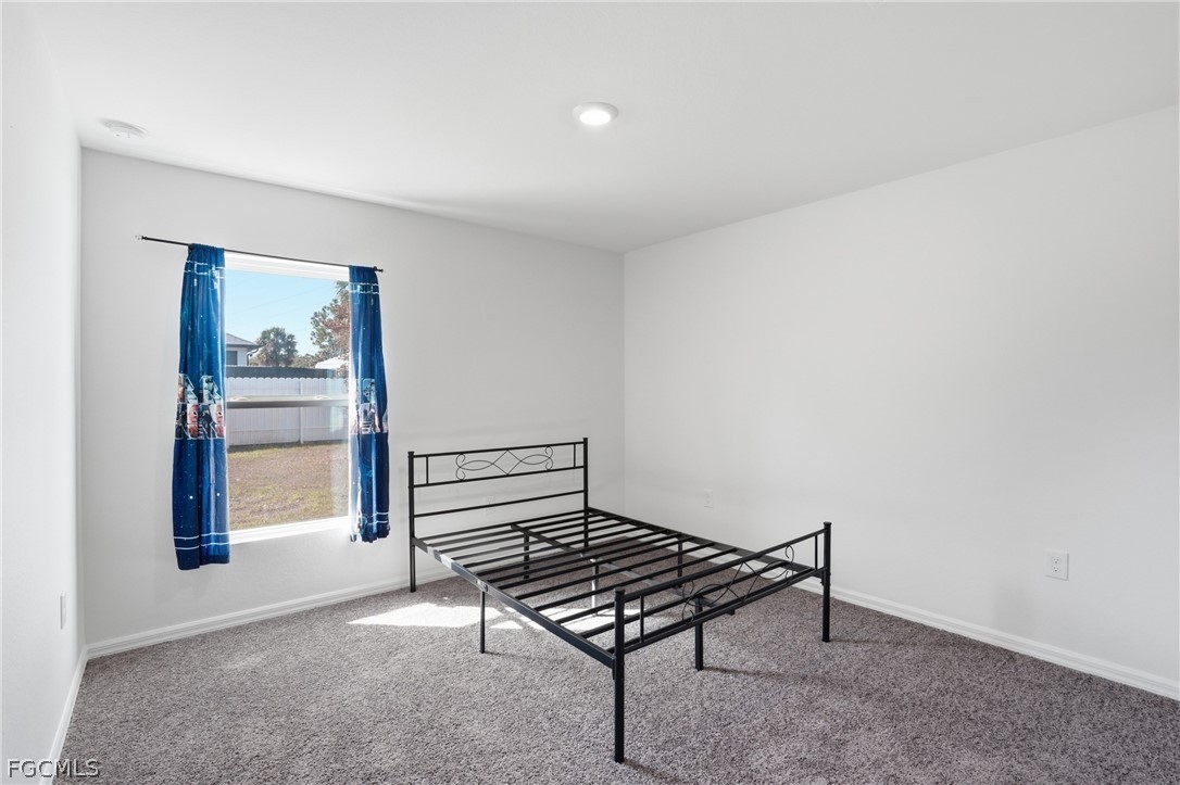 3319 40th Street West Lehigh Acres, FL 33971 - Photo 23 of 45 a bedroom with a bed and a window