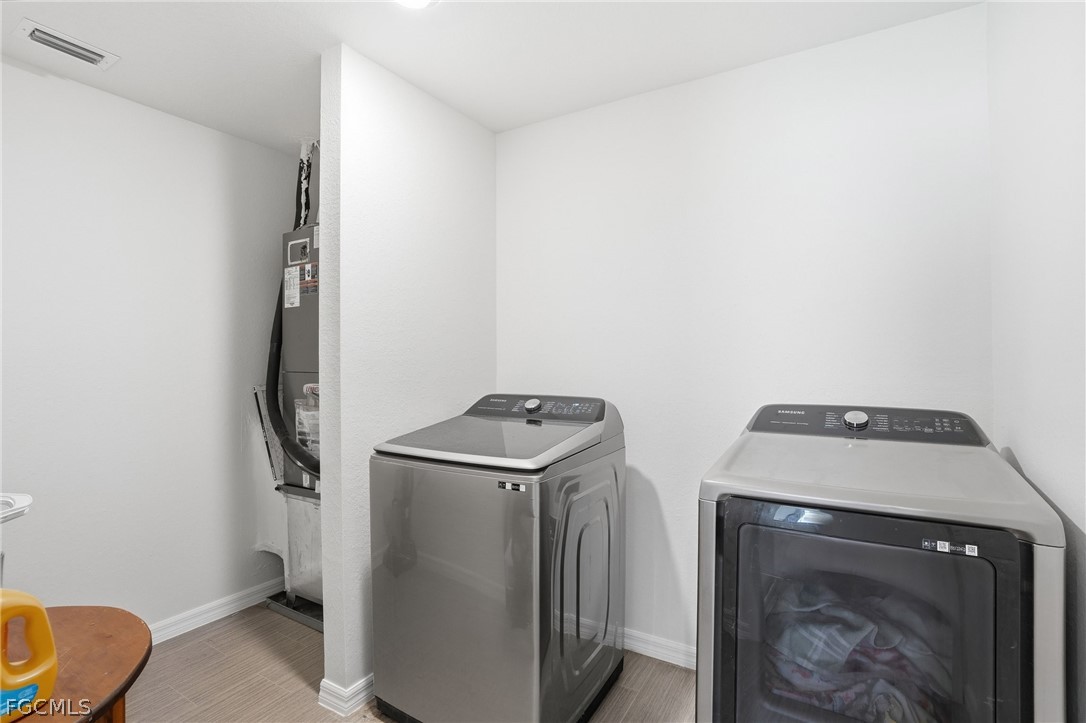 3319 40th Street West Lehigh Acres, FL 33971 - Photo 27 of 45 a utility room with dryer and washer