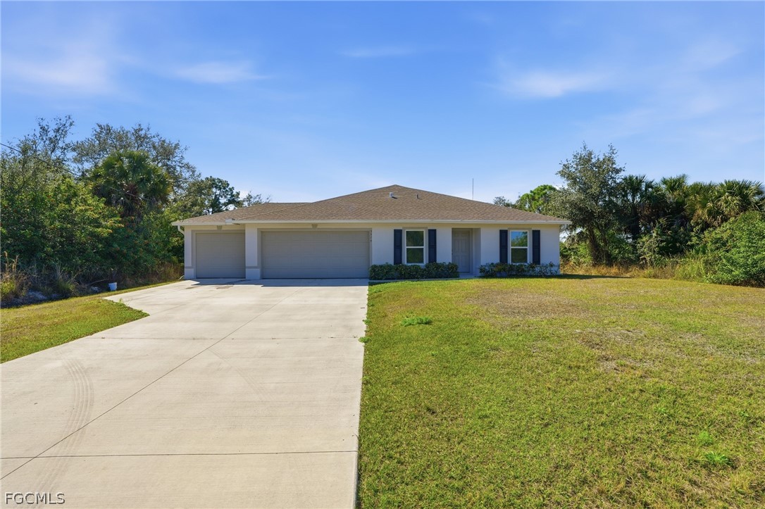 3319 40th Street West Lehigh Acres, FL 33971 - Photo 31 of 45 a front view of a house with a yard