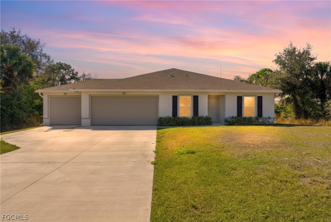 3319 40th Street West Lehigh Acres, FL 33971 - Photo 32 of 45 a front view of a house with a yard