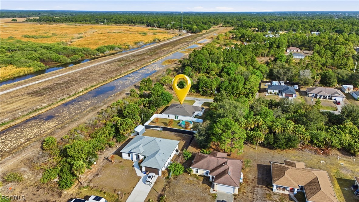 3319 40th Street West Lehigh Acres, FL 33971 - Photo 40 of 45 an aerial view of a house with a garden and lake view