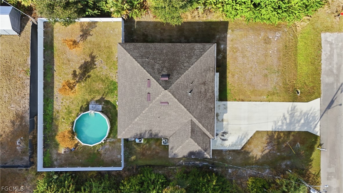 3319 40th Street West Lehigh Acres, FL 33971 - Photo 42 of 45 an aerial view of a house with swimming pool and large trees