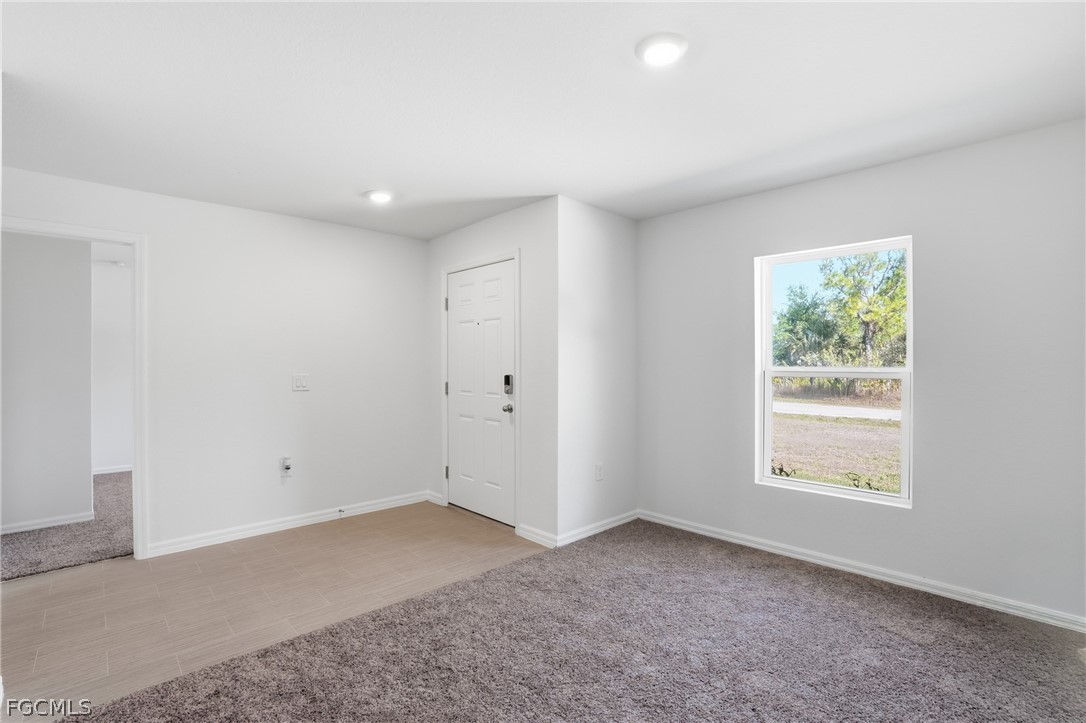 3319 40th Street West Lehigh Acres, FL 33971 - Photo 5 of 45 a view of an empty room with a window