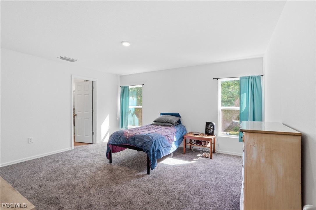3319 40th Street West Lehigh Acres, FL 33971 - Photo 7 of 45 a bed room with a bed and a window