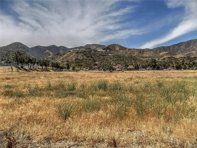 a view of mountain with sunset in background