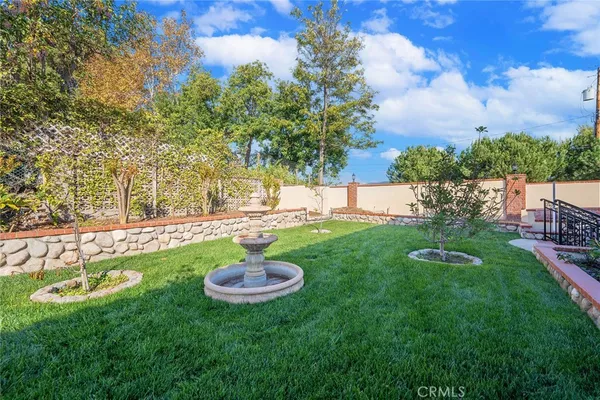 a view of a backyard with swimming pool