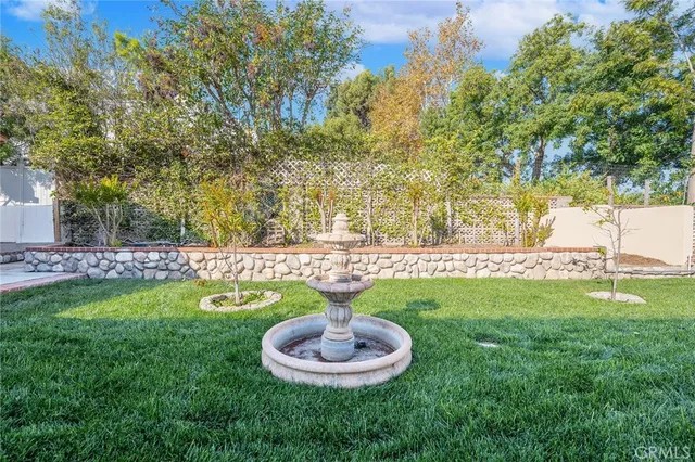 a backyard of a house with a yard and outdoor seating