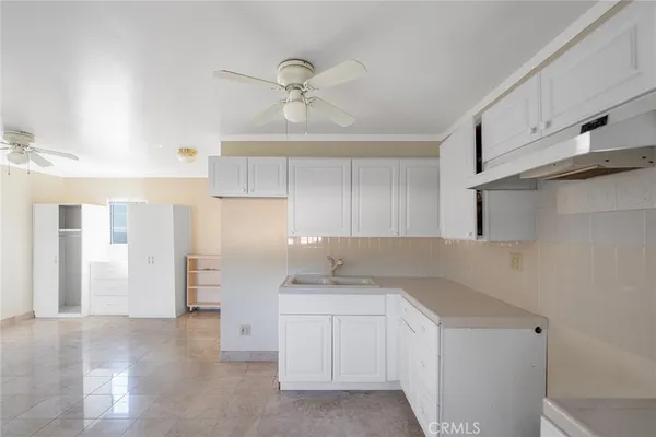 a kitchen with a sink cabinets and window