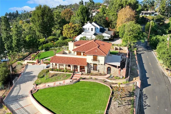an aerial view of a house with swimming pool garden and patio