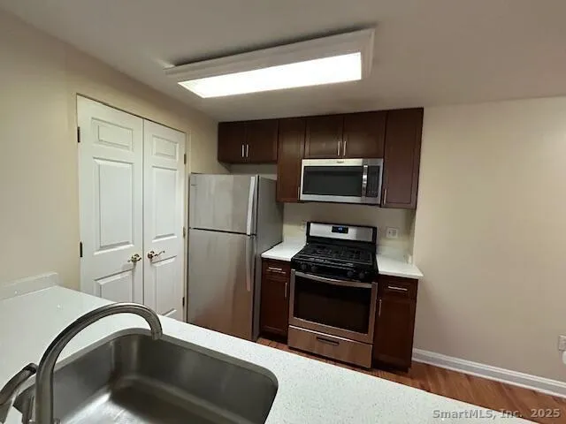 a kitchen with a refrigerator sink and stove