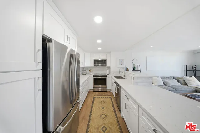 a large white kitchen with a large window