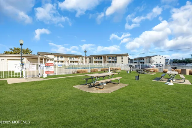 a swimming pool with outdoor seating and yard