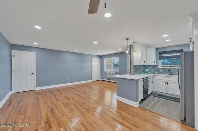 a view of kitchen with granite countertop cabinets and wooden floor