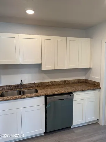 a kitchen with granite countertop white cabinets and a granite counter tops