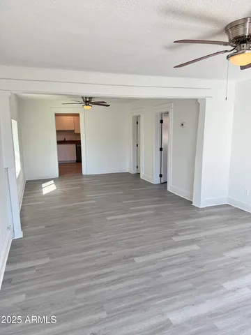 a view of empty room with wooden floor