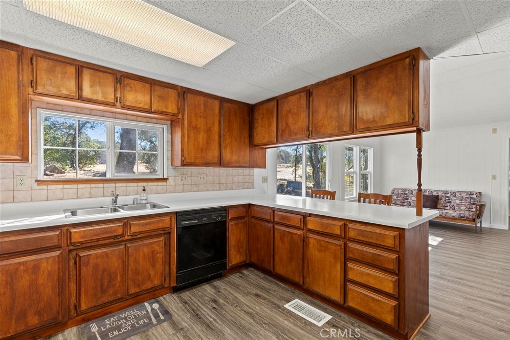75 Obert Drive Bangor, CA 95914 - Photo 11 of 52 a kitchen with stainless steel appliances granite countertop wooden cabinets a sink and dishwasher with wooden floor