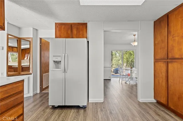 a view of a hallway with wooden floor windows and a livingroom