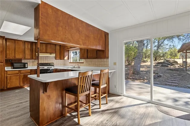 a kitchen with a stove a sink and a refrigerator