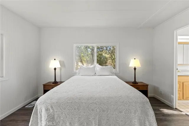 a bedroom with a bed and a lamp