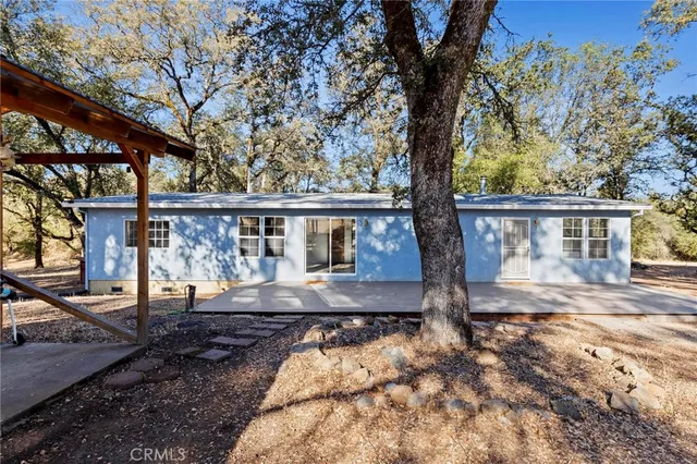 a view of house with backyard space and balcony