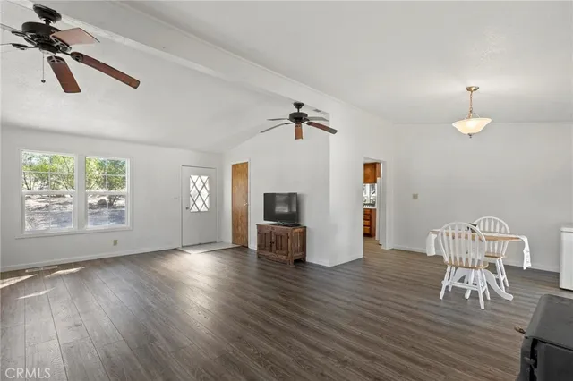 a view of a livingroom with furniture and a ceiling fan