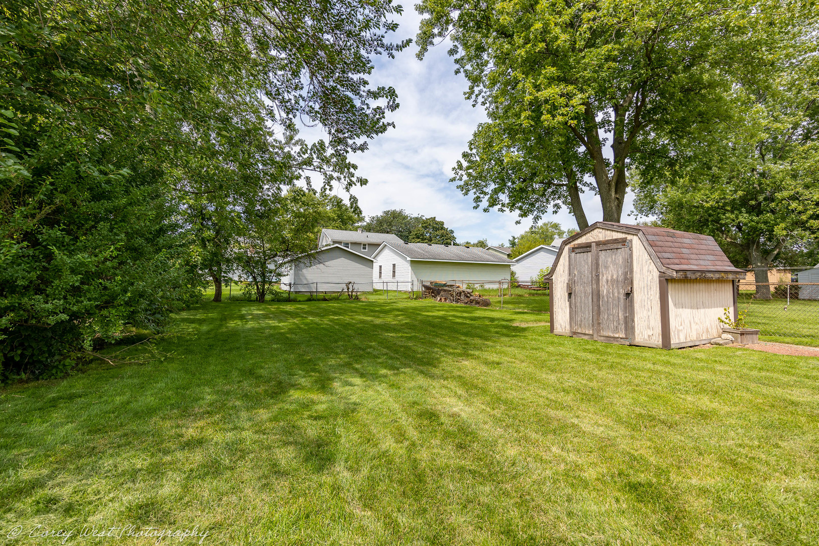 1233 Wild Street Sycamore, IL 60178 - Photo 17 of 18 a front view of a house with a yard and trees