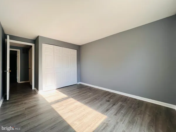 a view of an empty room and wooden floor