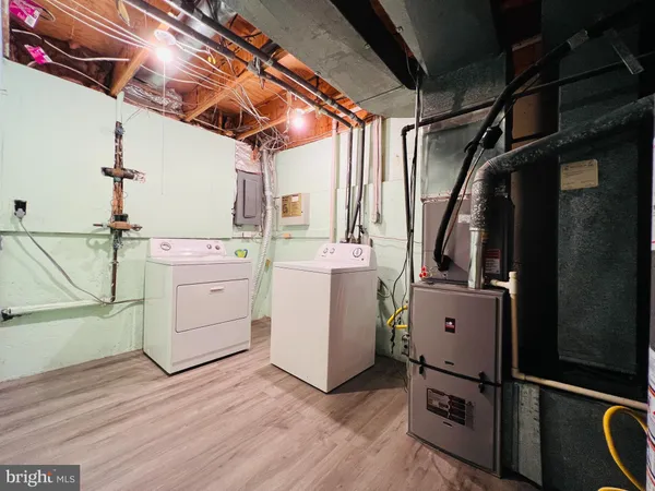 a view of a storage & utility room with racks dryer